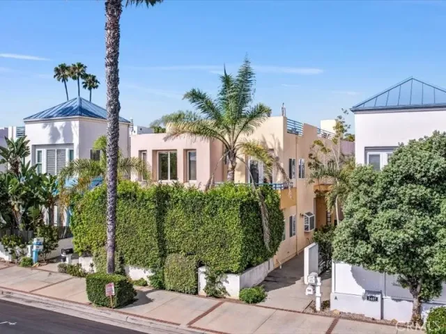 a front view of a house with a yard and tree s