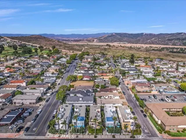a front view of a house with lots of green space and garden