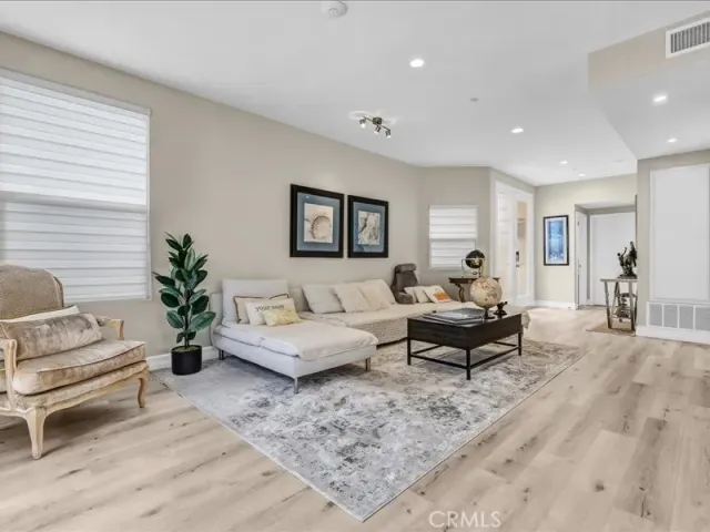 a living room with fireplace furniture and a dining table