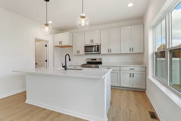 a kitchen with sink and mirror