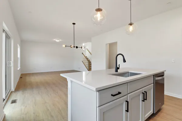 a kitchen with stainless steel appliances granite countertop a sink and a stove