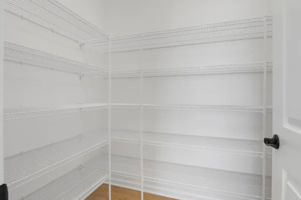 a view of an empty room with window wooden floor and front door