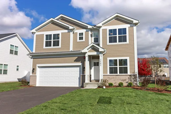 a front view of a house with a yard