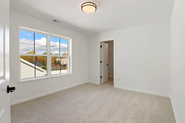 an empty room with windows and city view