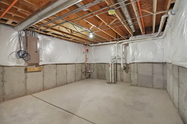 a view of an empty room with wooden ceiling