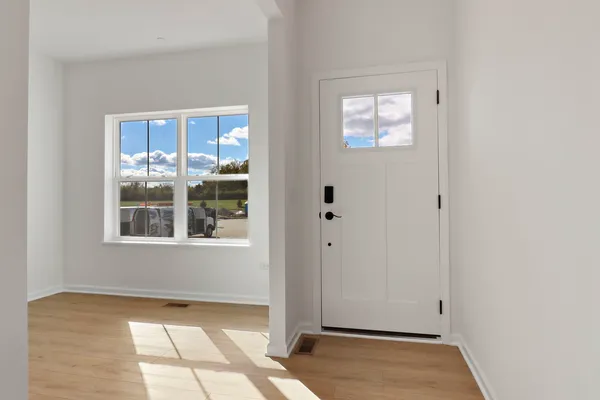 a view of a hallway with wooden floor