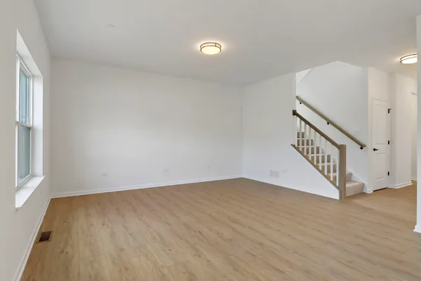 a view of a kitchen with wooden floor and a sink
