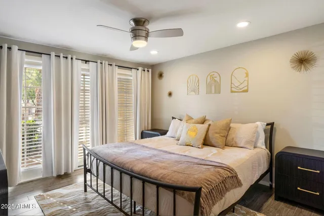 a bedroom with a large bed and a chandelier