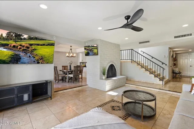 a living room with furniture a fireplace and a flat screen tv