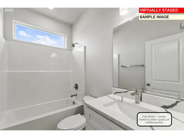 a bathroom with a granite countertop sink mirror toilet and bathtub