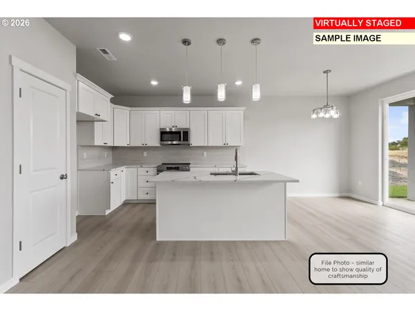 a kitchen with stainless steel appliances granite countertop a sink stove and cabinets