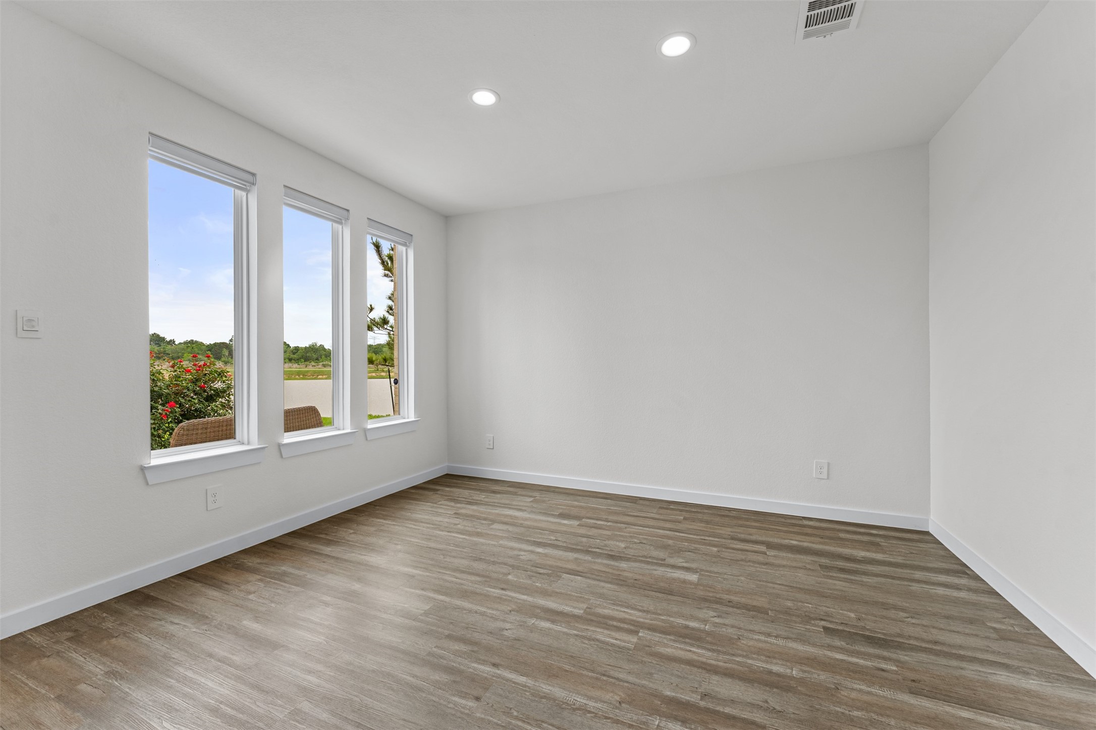 22503 Modica Rift Lane Katy, TX 77449 - Photo 4 of 47 wooden floor in an empty room with a window