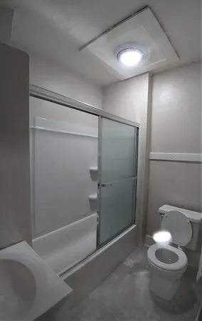 a bathroom with a shower and a toilet