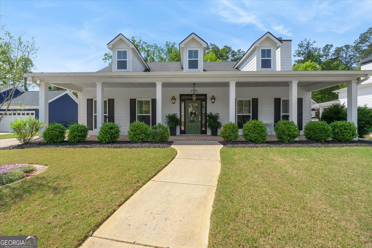a front view of a house with yard and green space