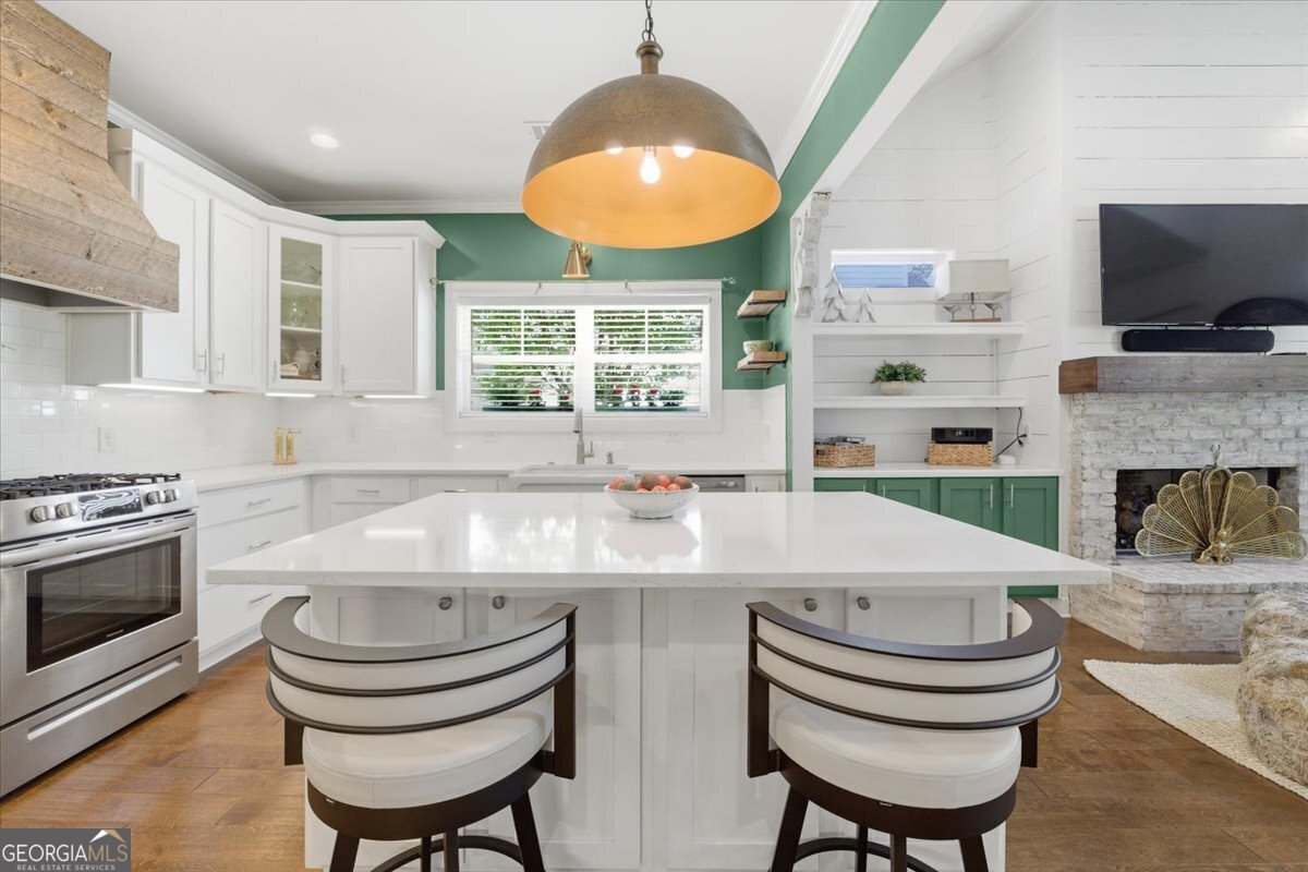 731 Markhams Drive Madison, GA 30650 - Photo 12 of 68 a kitchen with a stove a sink and a fireplace