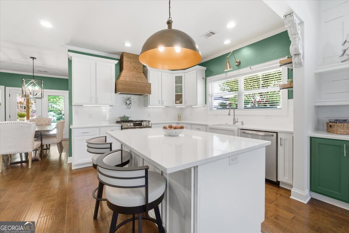 731 Markhams Drive Madison, GA 30650 - Photo 13 of 68 a kitchen with stainless steel appliances granite countertop a sink a stove and a refrigerator