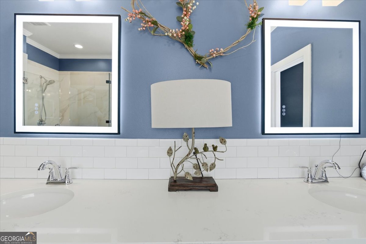 731 Markhams Drive Madison, GA 30650 - Photo 28 of 68 a bathroom with a sink and a mirror