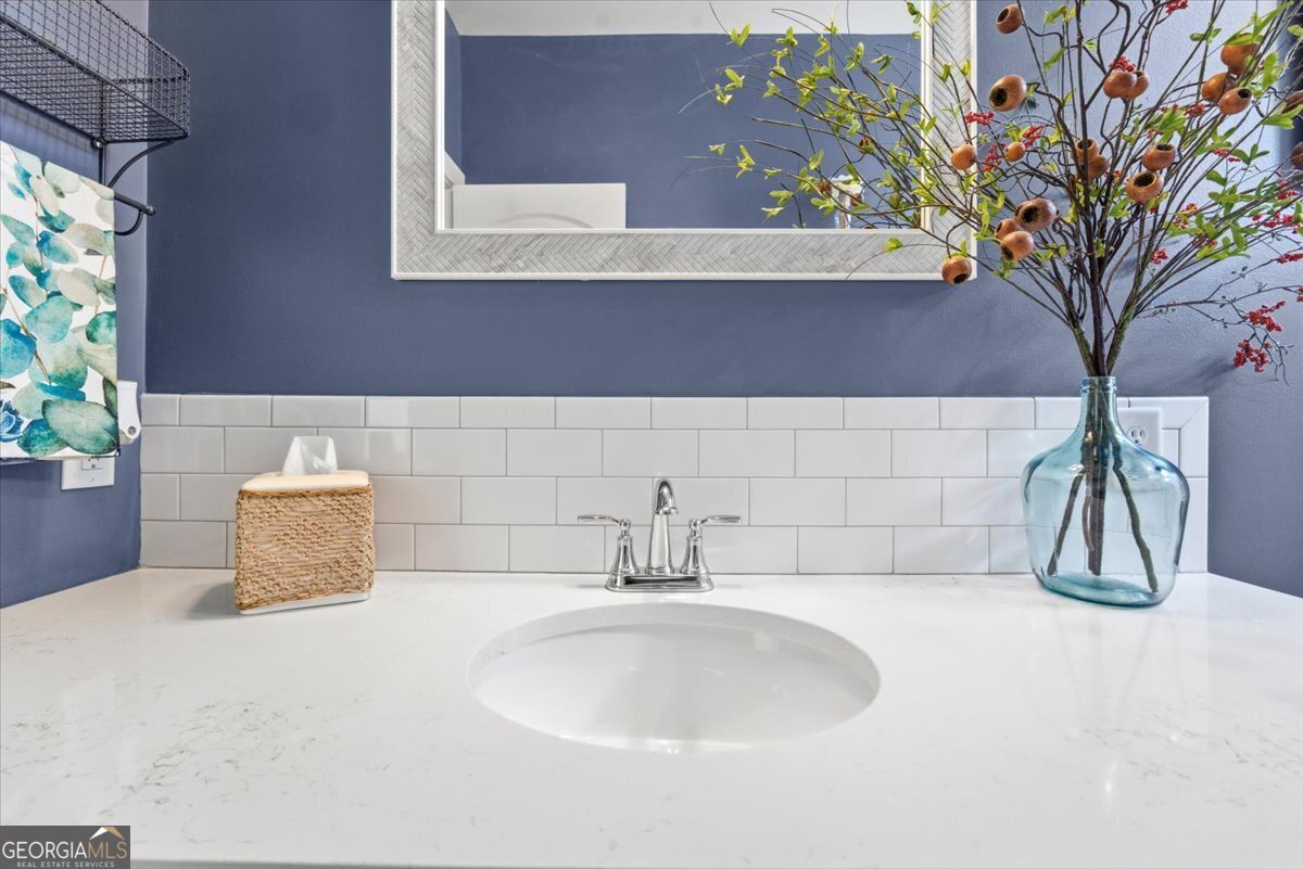 731 Markhams Drive Madison, GA 30650 - Photo 41 of 68 a bathroom with a sink and a mirror