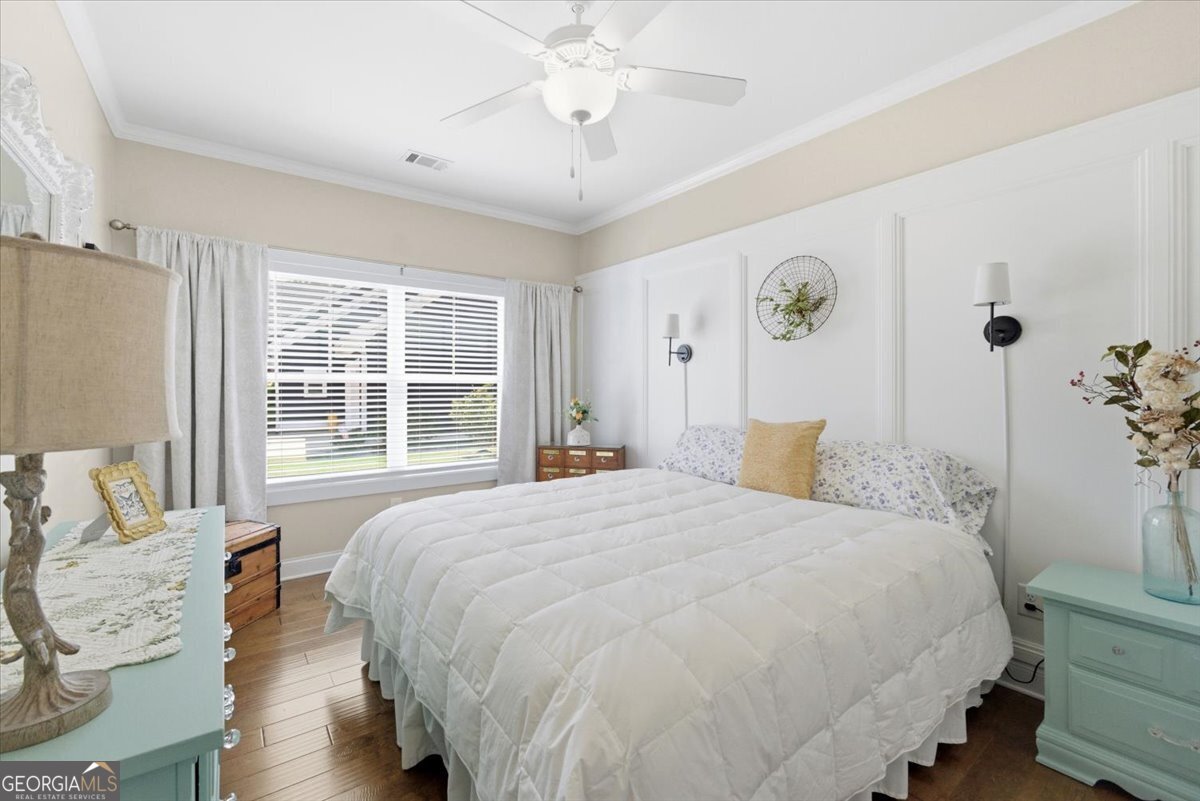 731 Markhams Drive Madison, GA 30650 - Photo 42 of 68 a bedroom with a bed and a table with chair