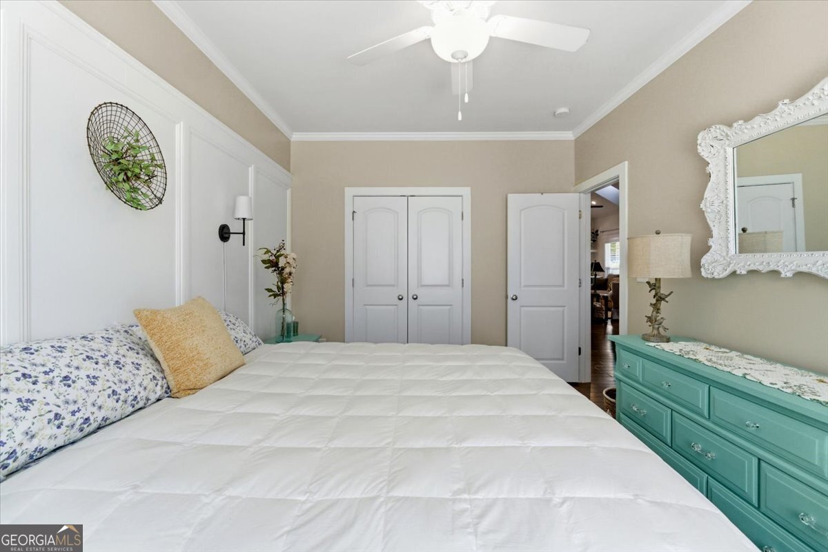 731 Markhams Drive Madison, GA 30650 - Photo 43 of 68 a spacious bedroom with a bed and a chandelier
