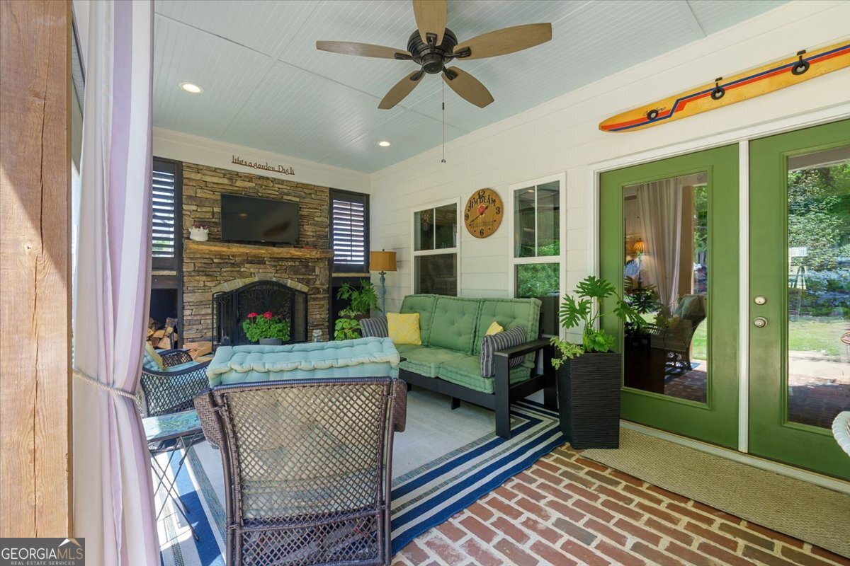 731 Markhams Drive Madison, GA 30650 - Photo 47 of 68 a living room with furniture a flat screen tv and a fireplace