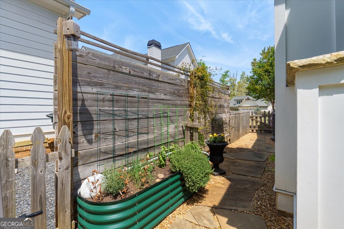 731 Markhams Drive Madison, GA 30650 - Photo 49 of 68 a view of a balcony with chair and potted plants