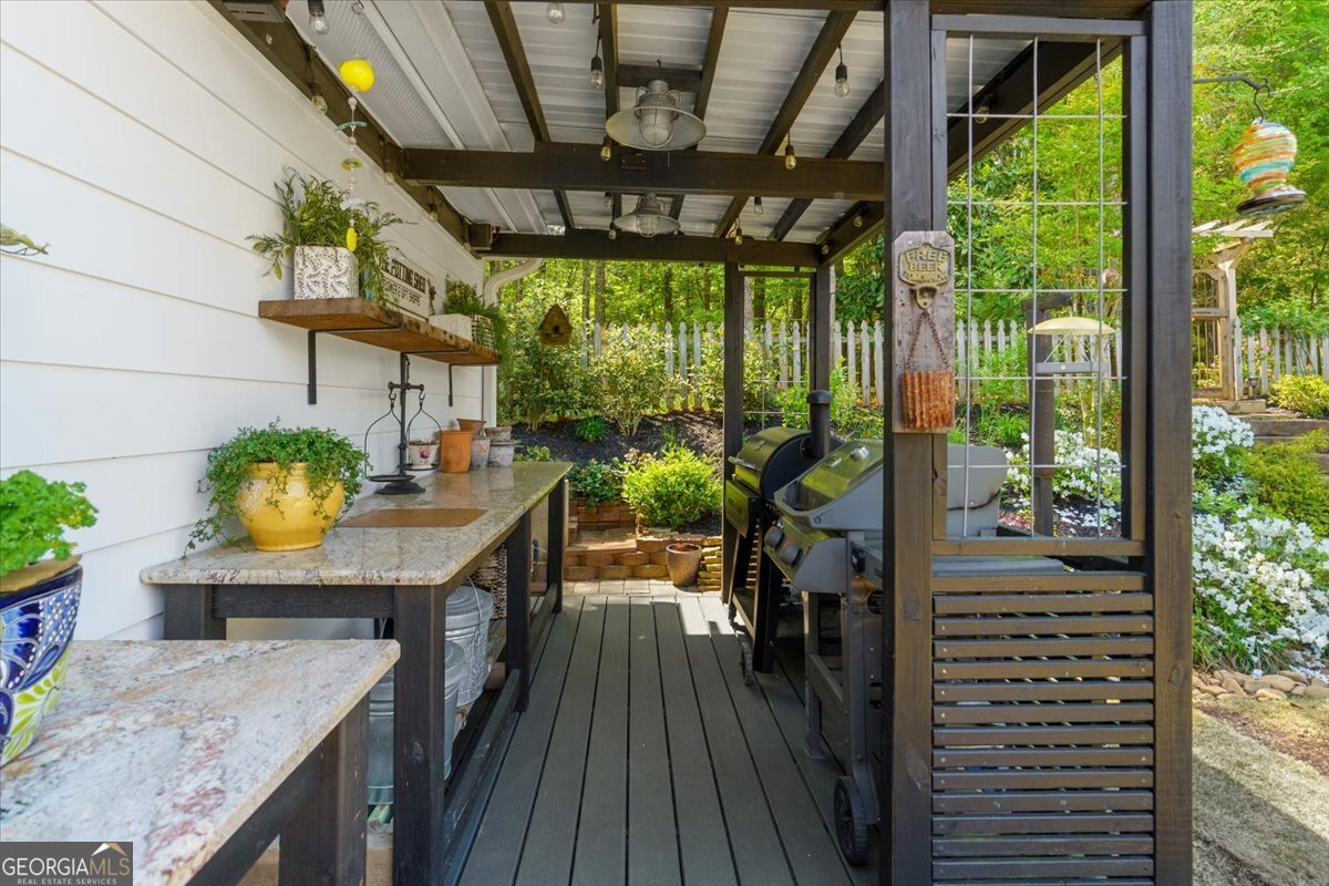 731 Markhams Drive Madison, GA 30650 - Photo 50 of 68 a view of a porch with furniture and wooden floor