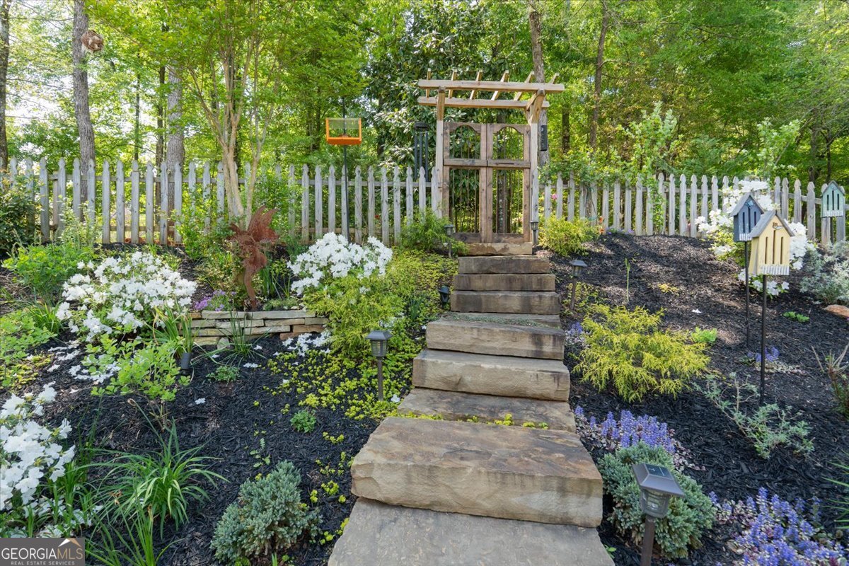 731 Markhams Drive Madison, GA 30650 - Photo 51 of 68 a view of a house with a garden