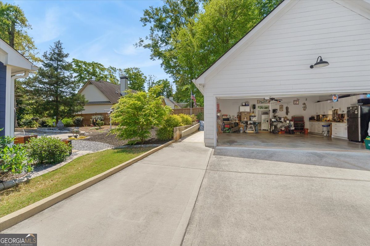 731 Markhams Drive Madison, GA 30650 - Photo 57 of 68 a view of a patio with table and chairs and potted plants