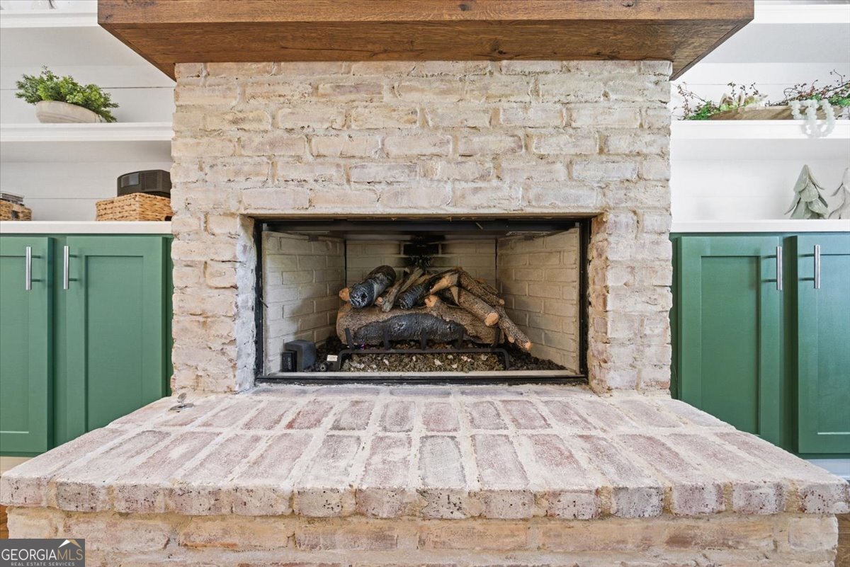 731 Markhams Drive Madison, GA 30650 - Photo 7 of 68 a bedroom with a bed and a fireplace