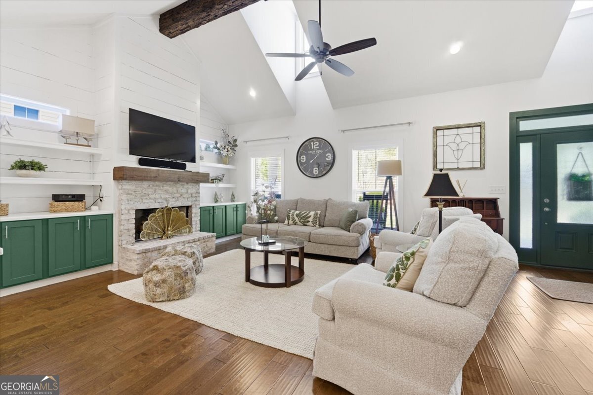 731 Markhams Drive Madison, GA 30650 - Photo 8 of 68 a living room with furniture a fireplace and a flat screen tv