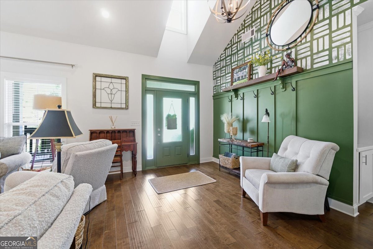 731 Markhams Drive Madison, GA 30650 - Photo 10 of 68 a living room with furniture floor to ceiling window and wooden floor