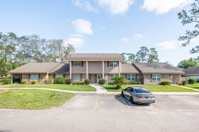 a car parked in front of white house