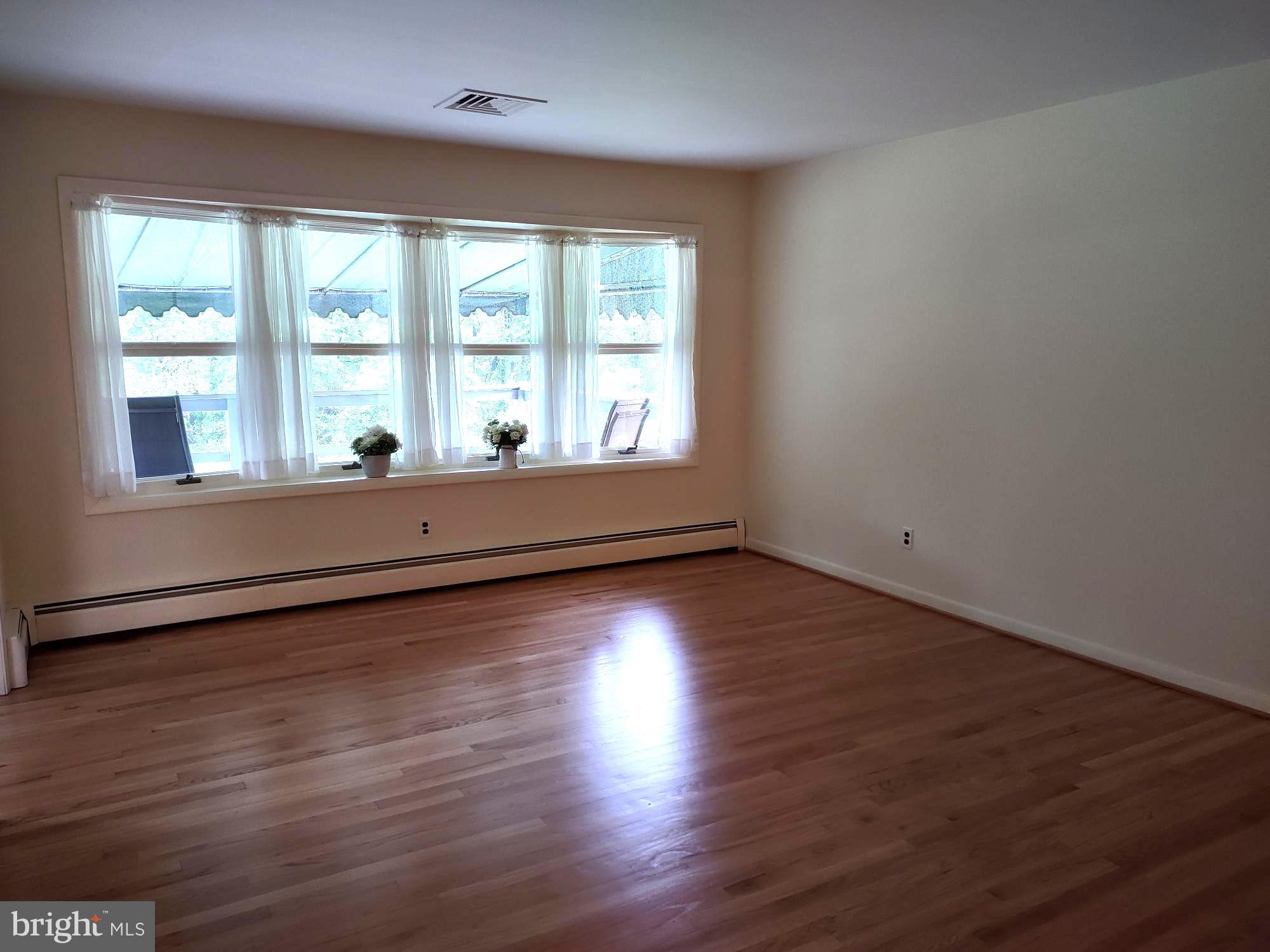 4103 Kincaid Road Baldwin, MD 21013 - Photo 13 of 73 an empty room with wooden floor and windows