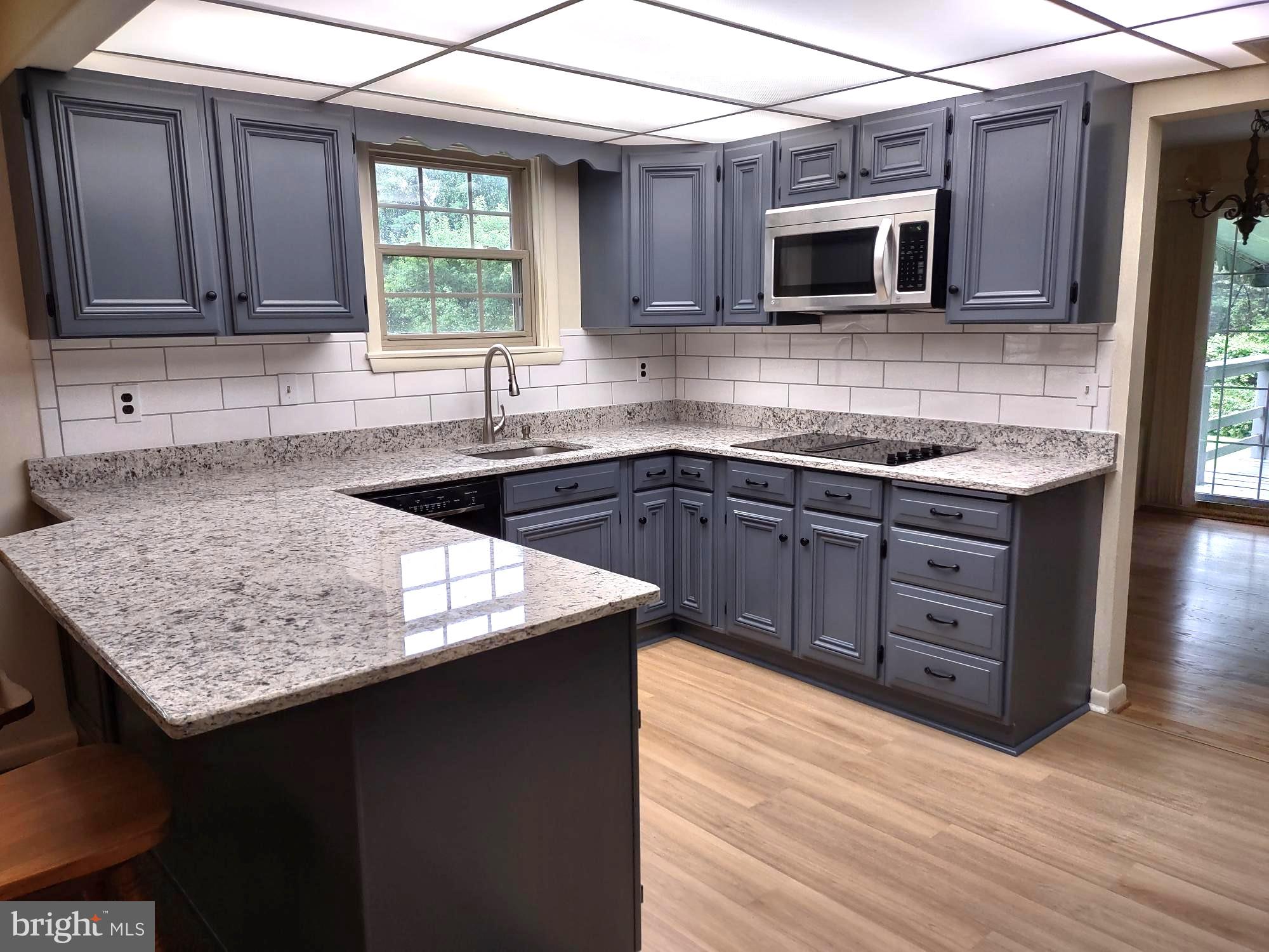 4103 Kincaid Road Baldwin, MD 21013 - Photo 23 of 73 a kitchen with stainless steel appliances granite countertop a sink stove and microwave