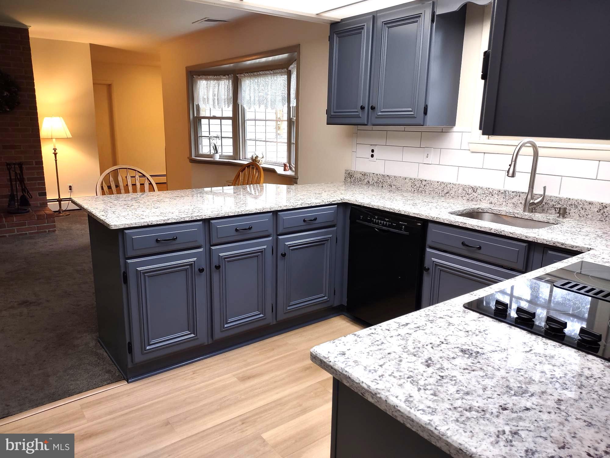 4103 Kincaid Road Baldwin, MD 21013 - Photo 25 of 73 a kitchen with stainless steel appliances granite countertop wooden cabinets a sink and dishwasher