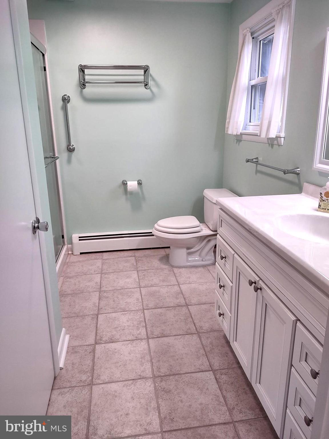 4103 Kincaid Road Baldwin, MD 21013 - Photo 38 of 73 a bathroom with a granite countertop sink a toilet and a shower