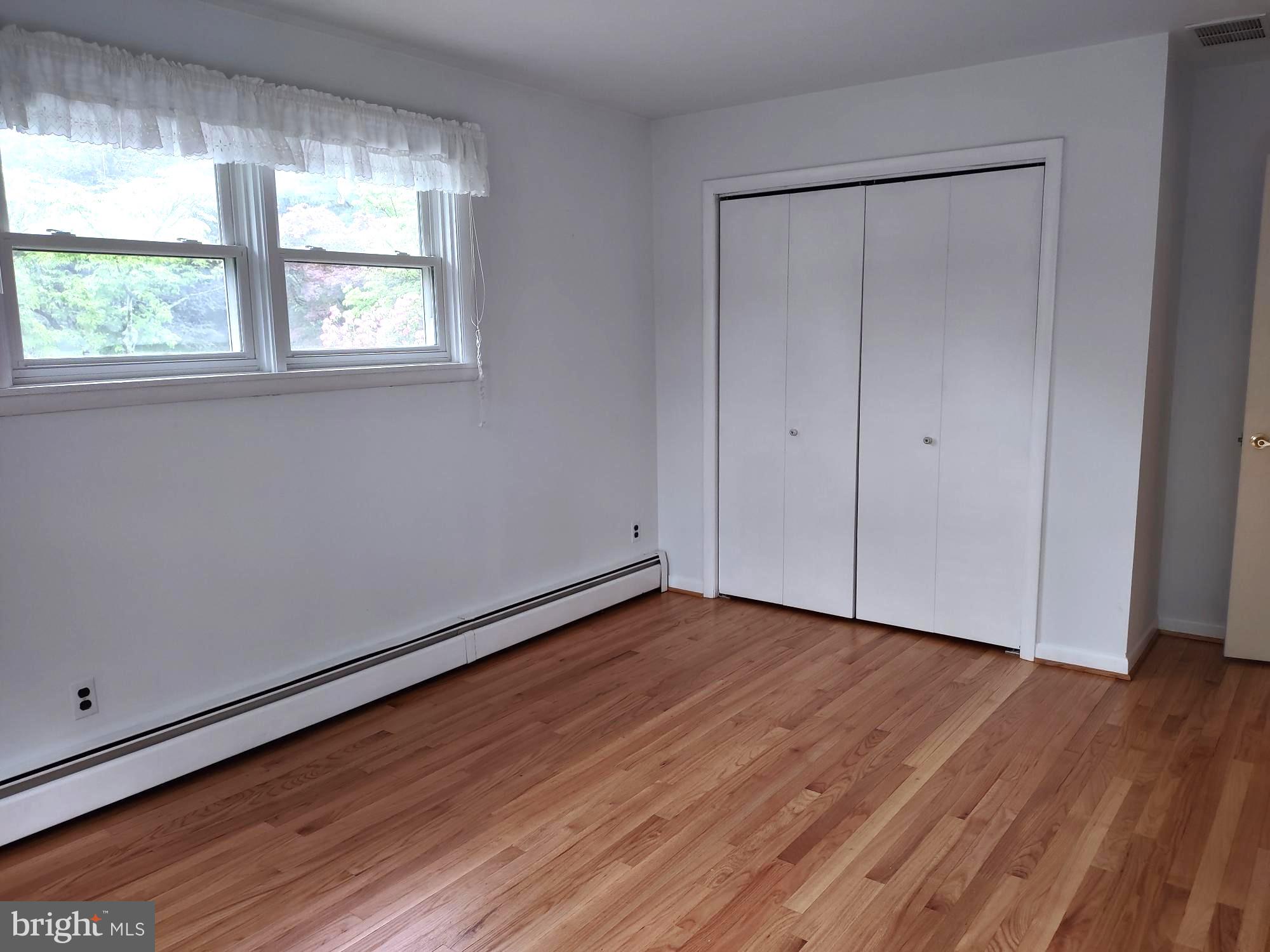 4103 Kincaid Road Baldwin, MD 21013 - Photo 45 of 73 a view of an empty room with wooden floor and a window