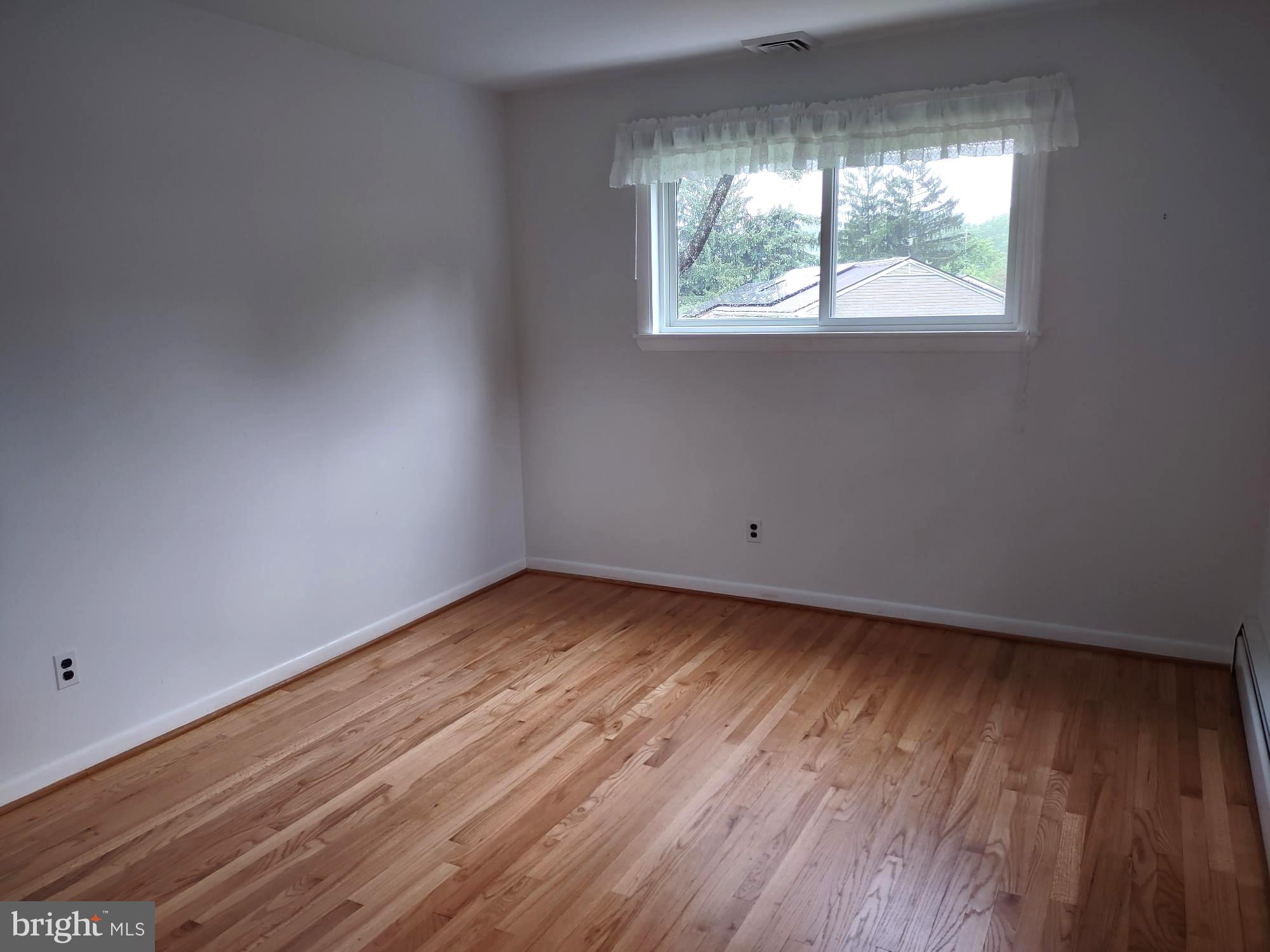 4103 Kincaid Road Baldwin, MD 21013 - Photo 46 of 73 an empty room with wooden floor and windows