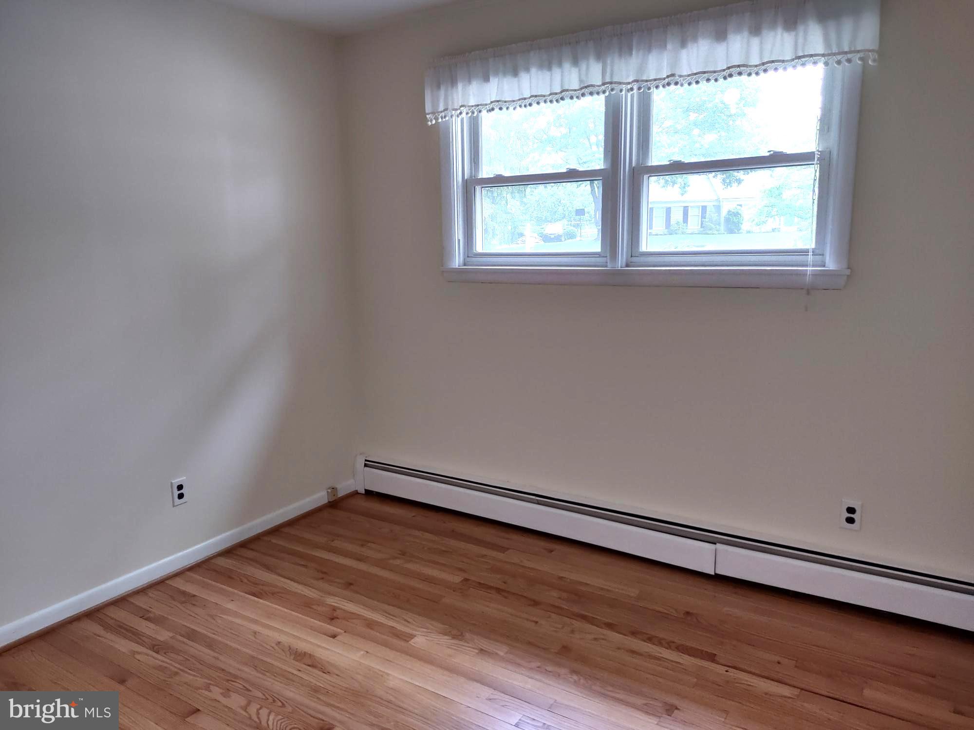 4103 Kincaid Road Baldwin, MD 21013 - Photo 49 of 73 an empty room with wooden floor and windows