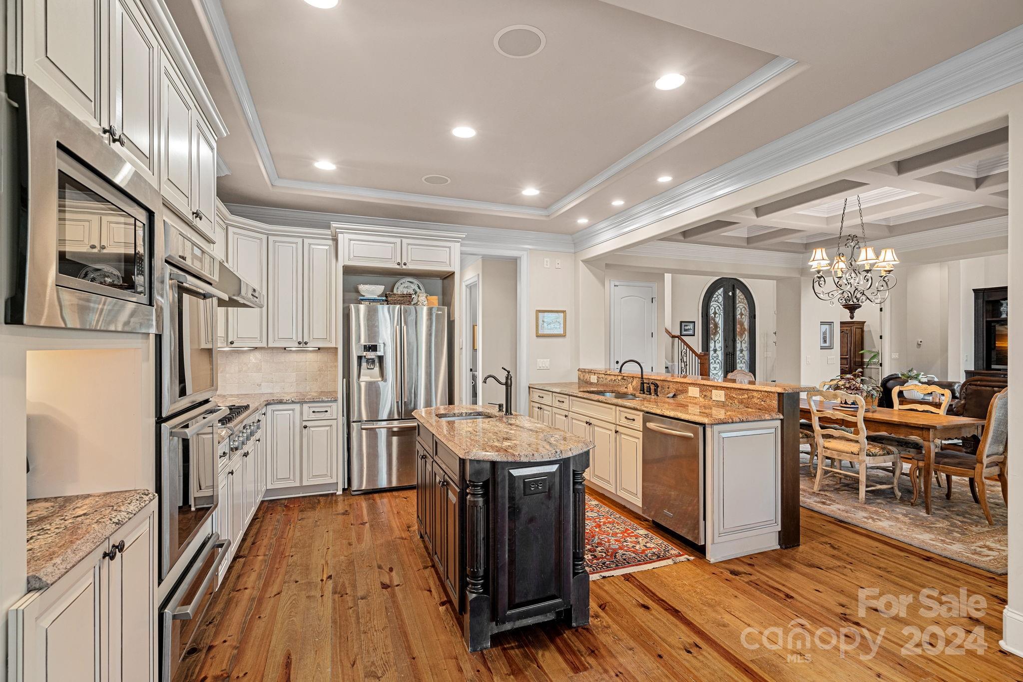2017 Brawley School Road Mooresville, NC 28117 - Photo 13 of 43 a kitchen with stainless steel appliances granite countertop a refrigerator oven a sink dishwasher and white cabinets with wooden floor