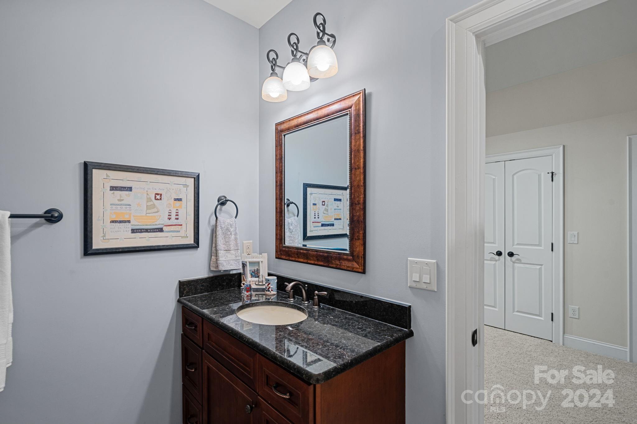 2017 Brawley School Road Mooresville, NC 28117 - Photo 24 of 43 a bathroom with a granite countertop sink and a mirror