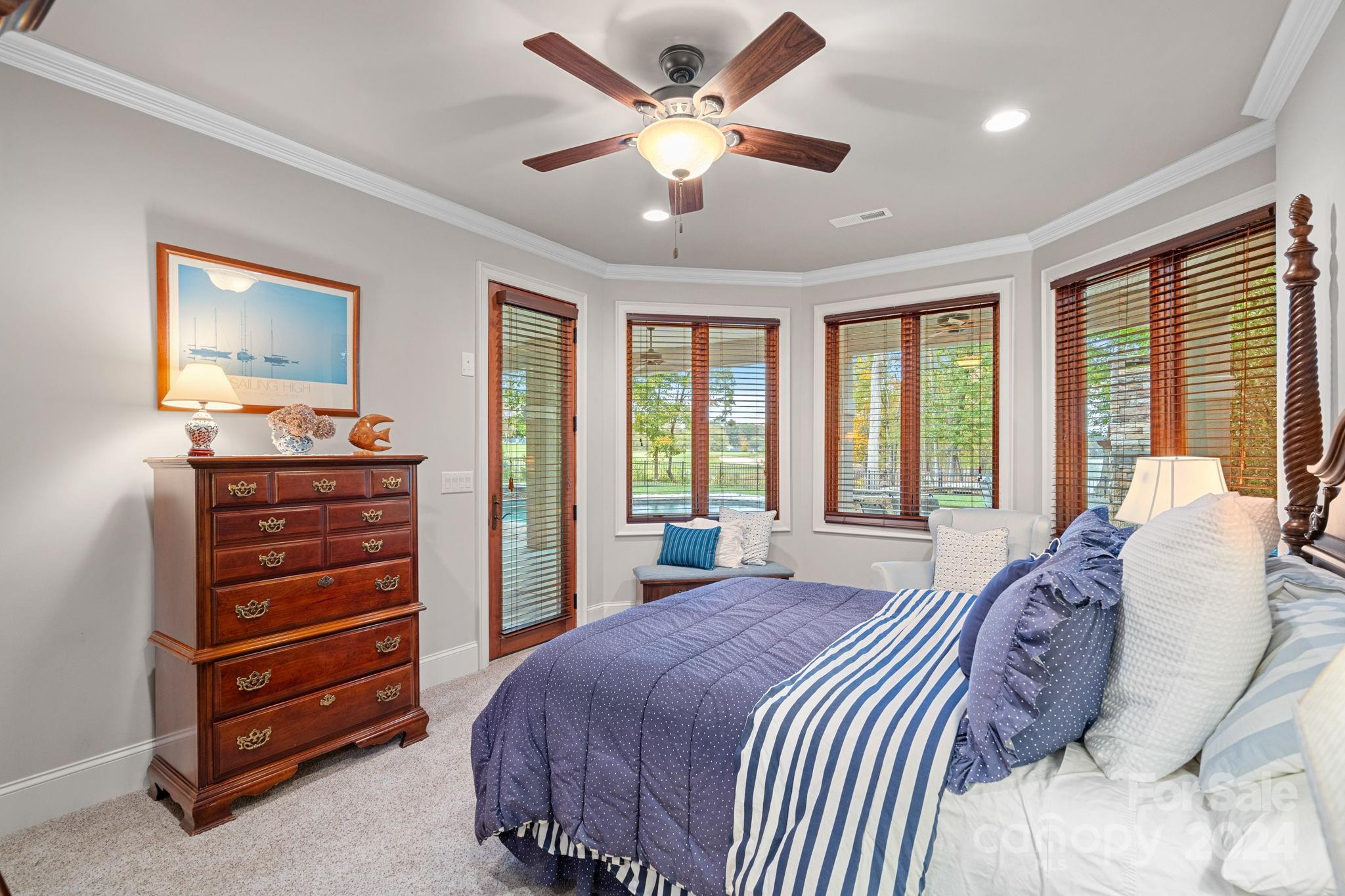 2017 Brawley School Road Mooresville, NC 28117 - Photo 28 of 43 a bedroom with a bed and a chandelier