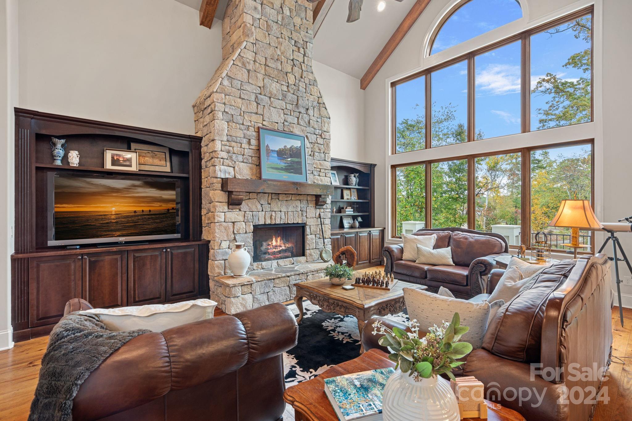 2017 Brawley School Road Mooresville, NC 28117 - Photo 9 of 43 a living room with furniture a fireplace and a flat screen tv