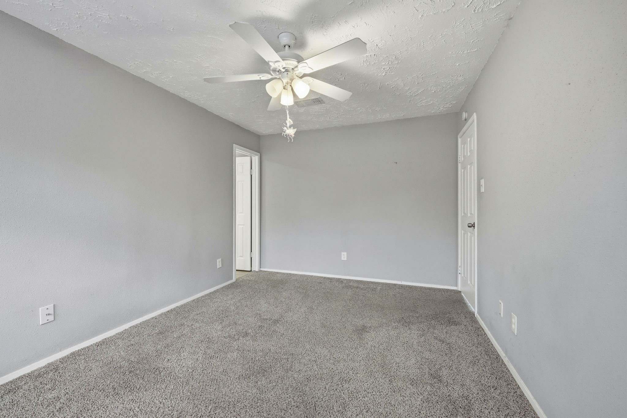 5421 Diane Court Spring, TX 77373 - Photo 22 of 24 an empty room with a chandelier fan and windows