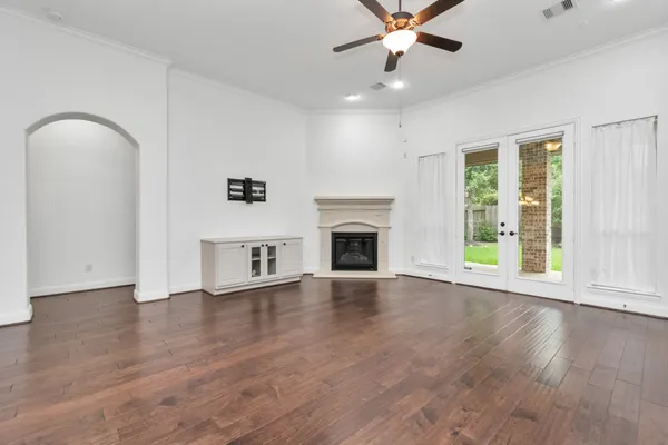 a view of a room with wooden floor and chandelier