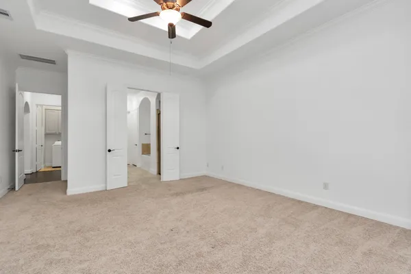 an empty room with chandelier fan