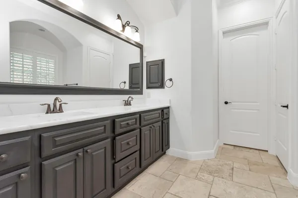 a spacious bathroom with a tub sink and mirror