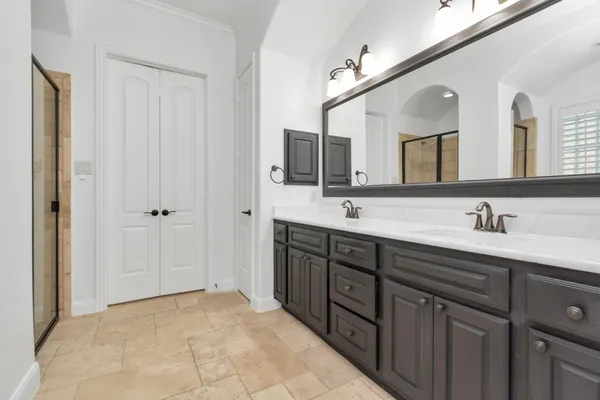 a spacious bathroom with a tub sink and mirror