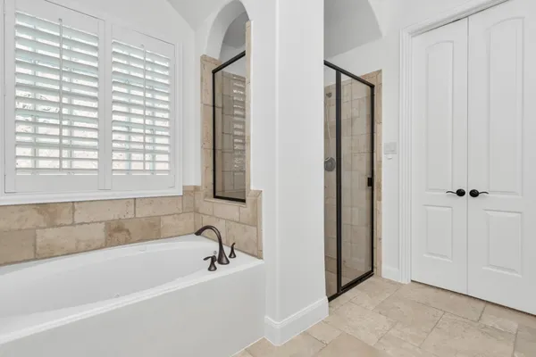 a spacious bathroom with a double vanity sink and a mirror